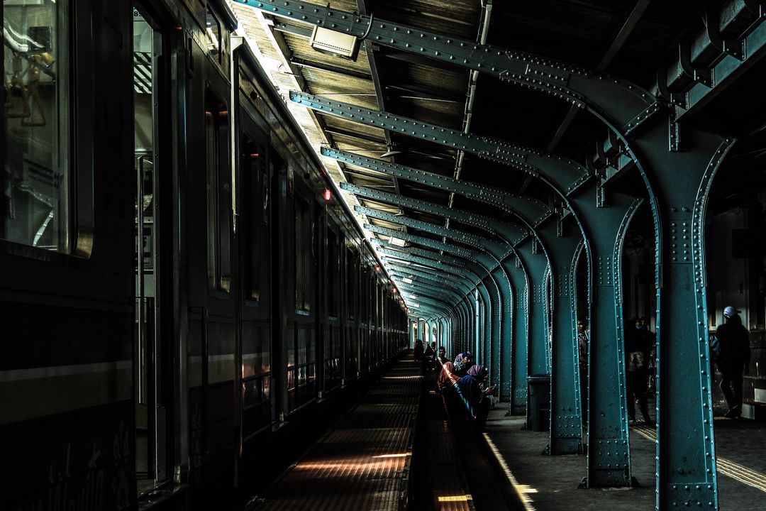 A train station with big metal columns